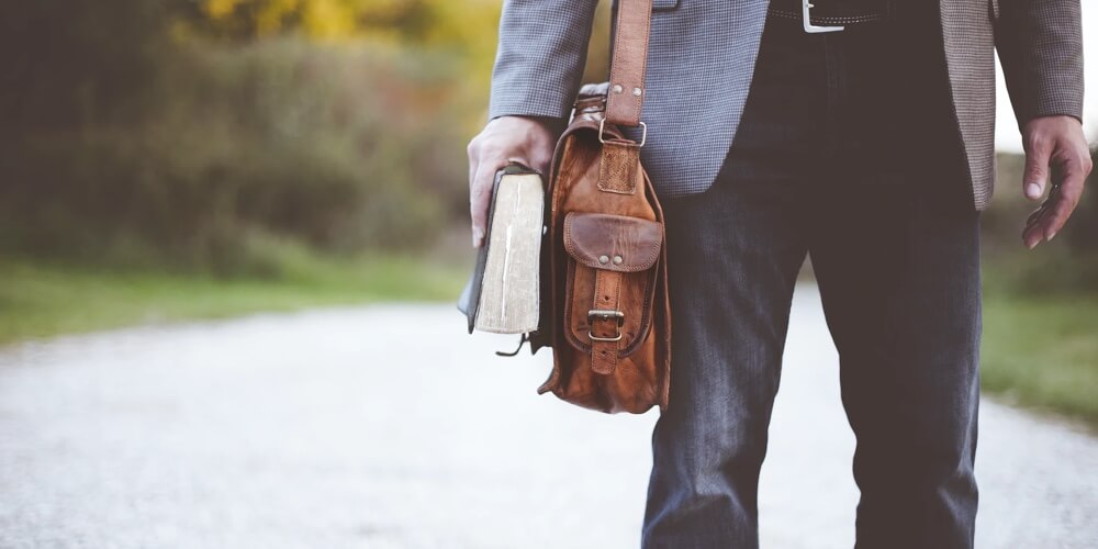 man carrying messenger bag 