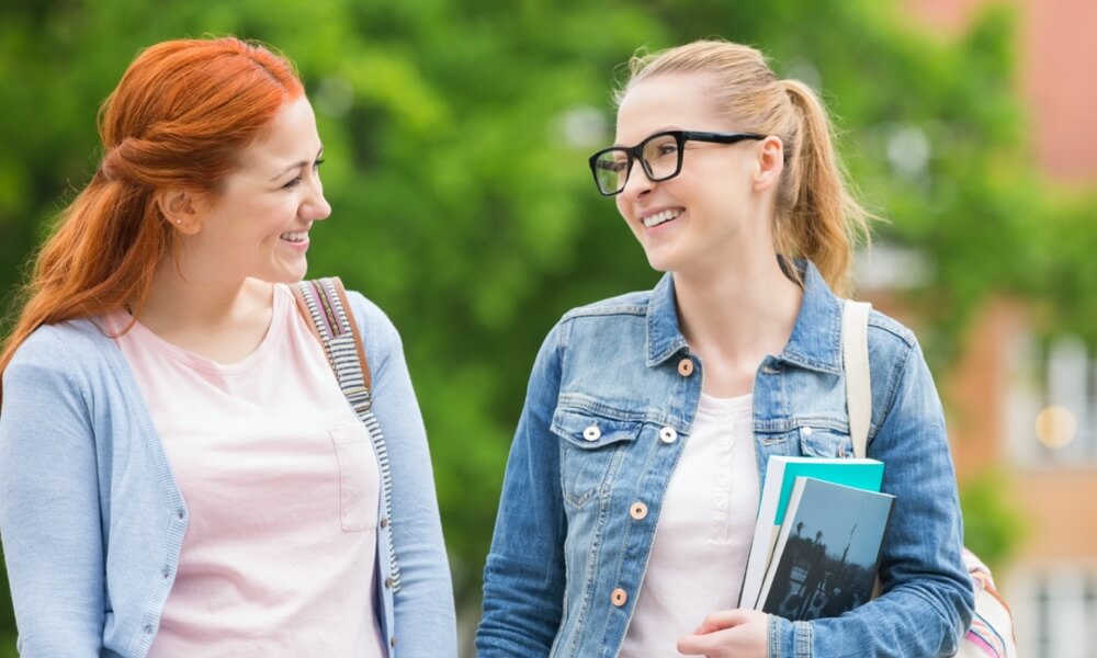 college girls carrying backpack